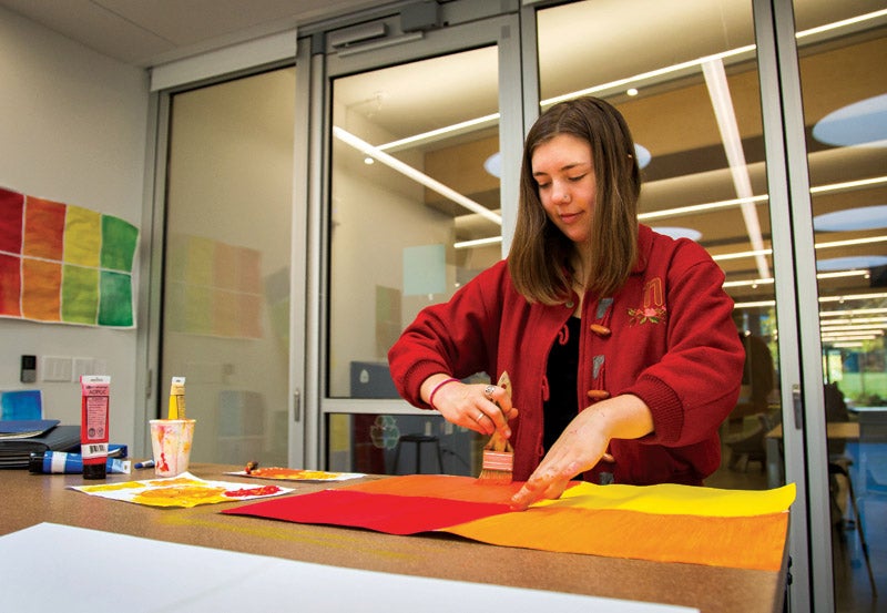 Come live with us in Kalapuya Ilihi and be part of a great community. Photo of student painting on canvas
